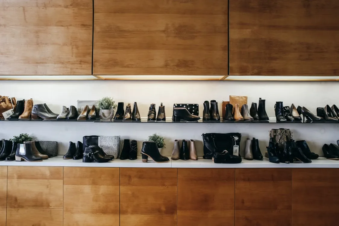 Footwear displayed on shelves in a retail store