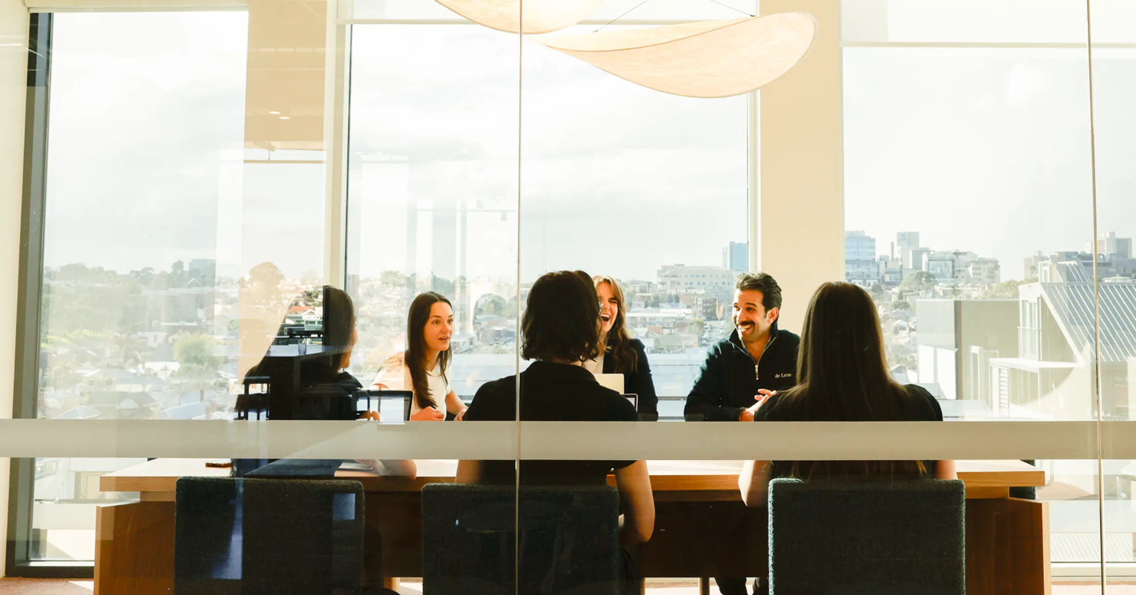 Customr team meeting around a boardroom table